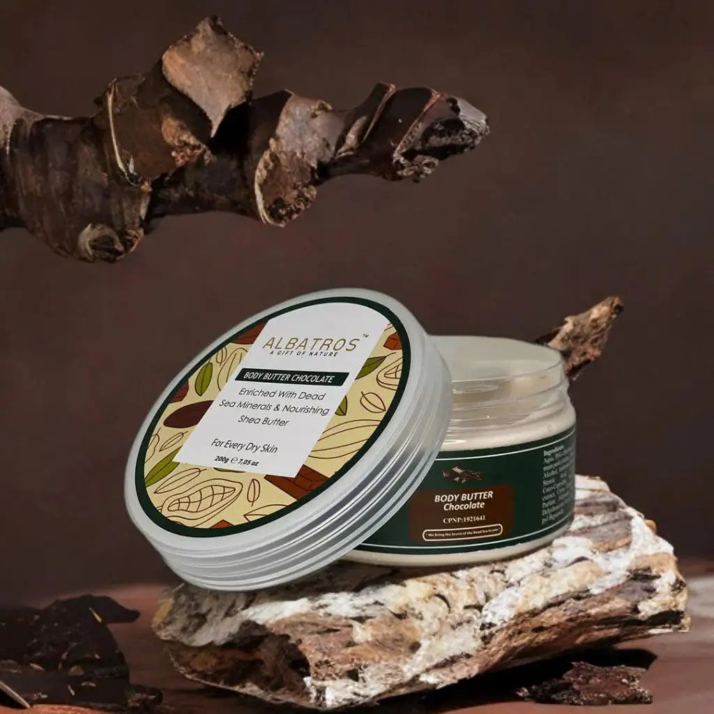 Jar of body butter with Albatros branding on a natural stone surface with wooden elements.